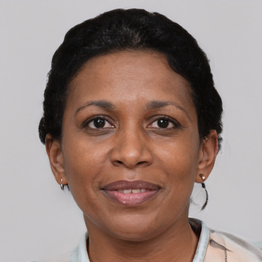 Joyful latino adult female with short  black hair and brown eyes