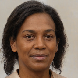 Joyful black adult female with medium  brown hair and brown eyes