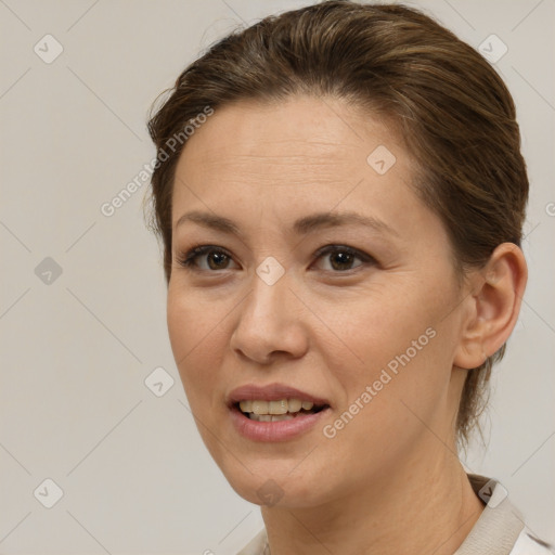 Joyful white adult female with medium  brown hair and brown eyes