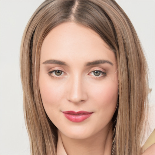 Joyful white young-adult female with long  brown hair and green eyes