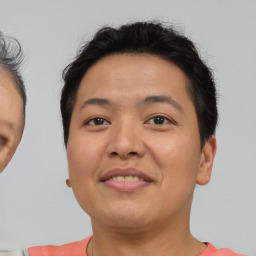 Joyful asian young-adult female with short  brown hair and brown eyes