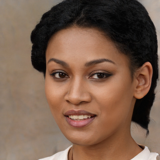 Joyful black young-adult female with medium  black hair and brown eyes