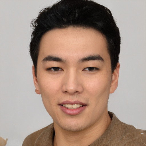 Joyful asian young-adult male with short  black hair and brown eyes