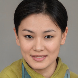 Joyful asian young-adult female with medium  brown hair and brown eyes