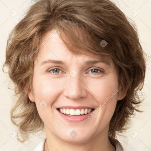 Joyful white young-adult female with medium  brown hair and green eyes