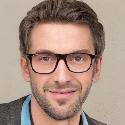 Joyful white adult male with short  brown hair and blue eyes