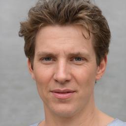 Joyful white adult male with short  brown hair and grey eyes