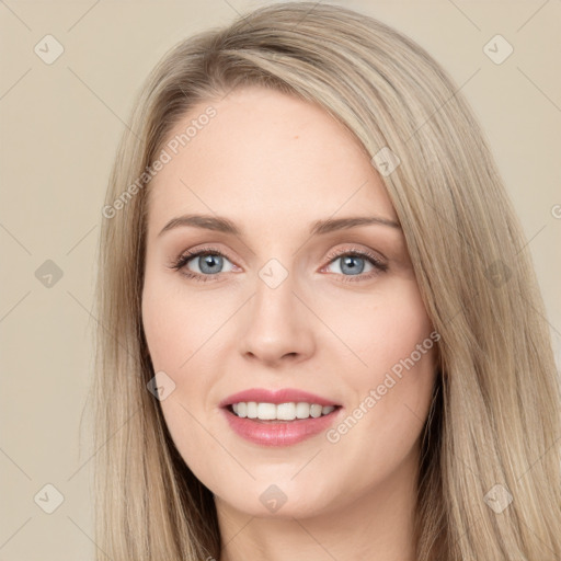 Joyful white young-adult female with long  brown hair and blue eyes