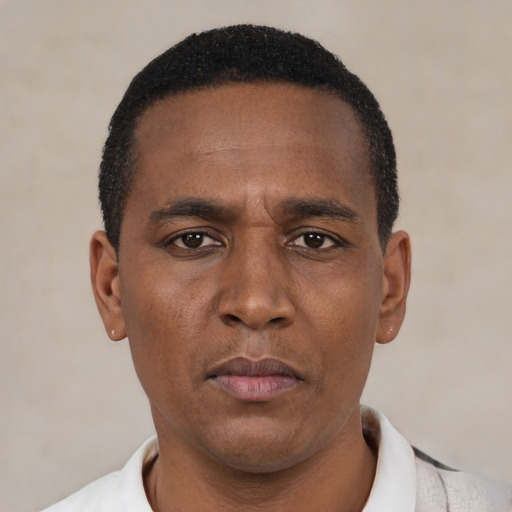 Neutral latino adult male with short  black hair and brown eyes