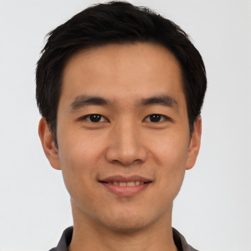 Joyful asian young-adult male with short  black hair and brown eyes