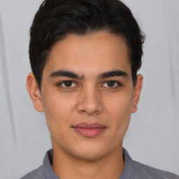 Joyful latino young-adult male with short  brown hair and brown eyes