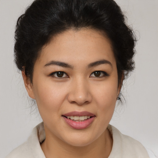 Joyful latino young-adult female with short  brown hair and brown eyes
