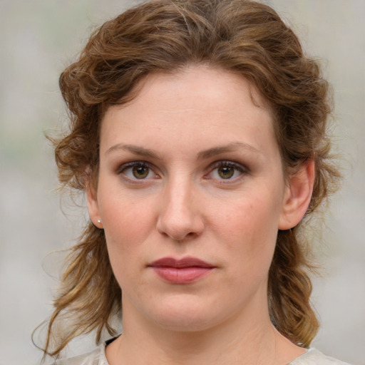 Joyful white young-adult female with medium  brown hair and blue eyes