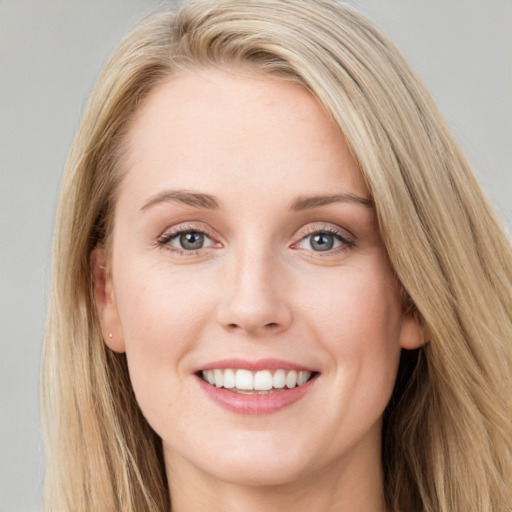 Joyful white young-adult female with long  brown hair and blue eyes