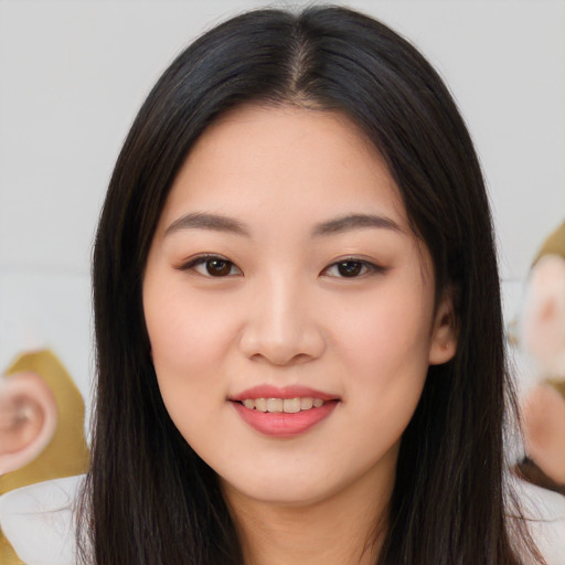 Joyful asian young-adult female with long  black hair and brown eyes