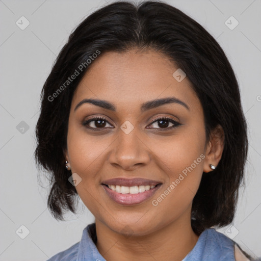 Joyful black young-adult female with medium  brown hair and brown eyes