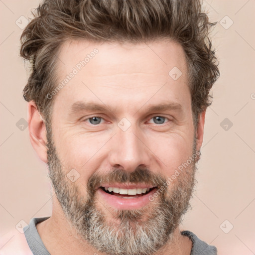 Joyful white adult male with short  brown hair and grey eyes