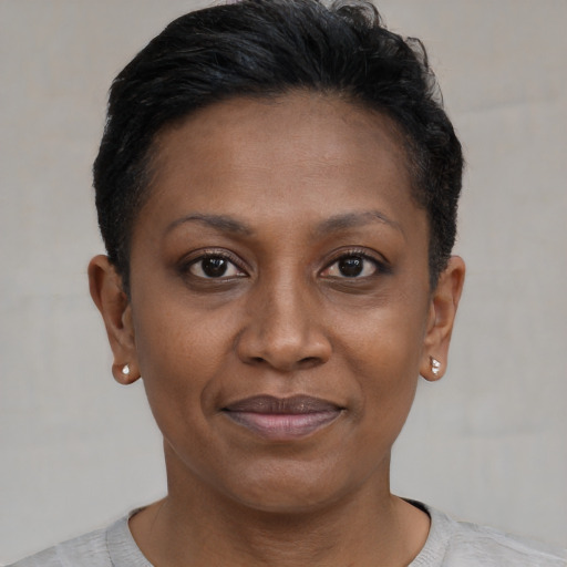 Joyful black adult female with short  brown hair and brown eyes