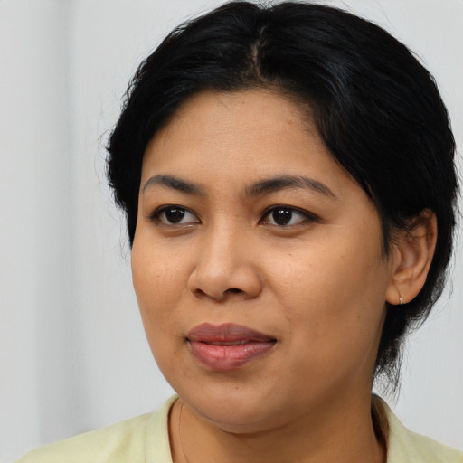 Joyful asian young-adult female with medium  black hair and brown eyes