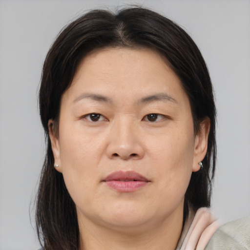 Joyful asian adult female with medium  brown hair and brown eyes