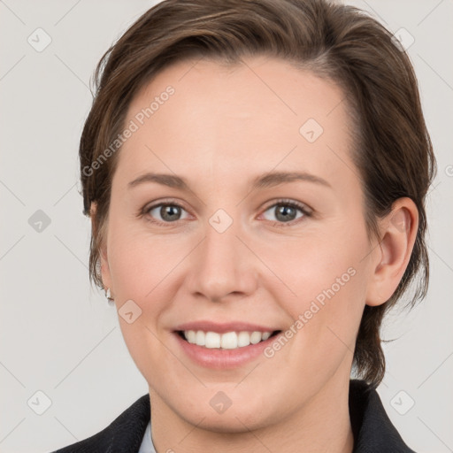 Joyful white young-adult female with medium  brown hair and grey eyes