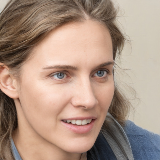 Joyful white young-adult female with medium  brown hair and blue eyes