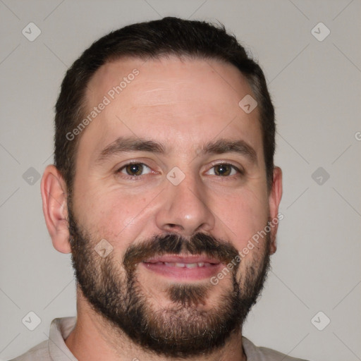 Joyful white adult male with short  brown hair and brown eyes