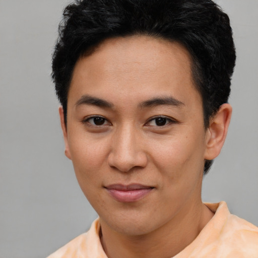 Joyful asian young-adult female with short  black hair and brown eyes