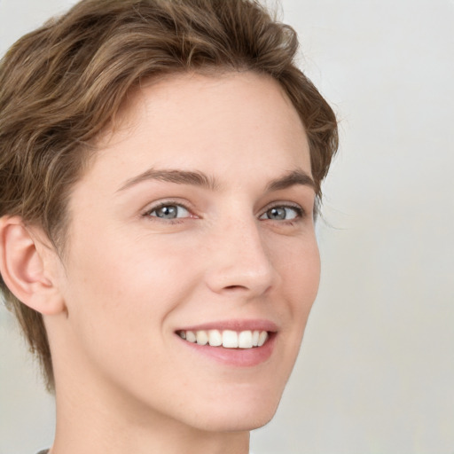 Joyful white young-adult female with short  brown hair and green eyes