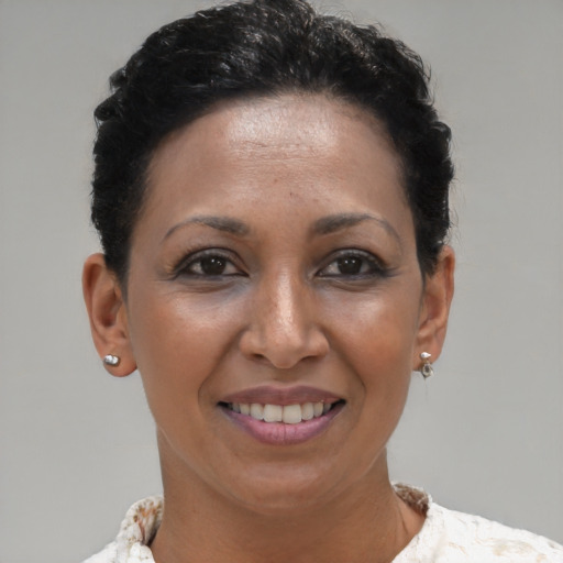 Joyful black young-adult female with short  brown hair and brown eyes