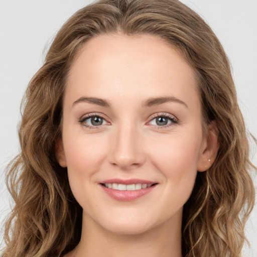 Joyful white young-adult female with long  brown hair and green eyes