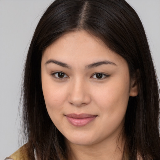 Joyful asian young-adult female with long  brown hair and brown eyes