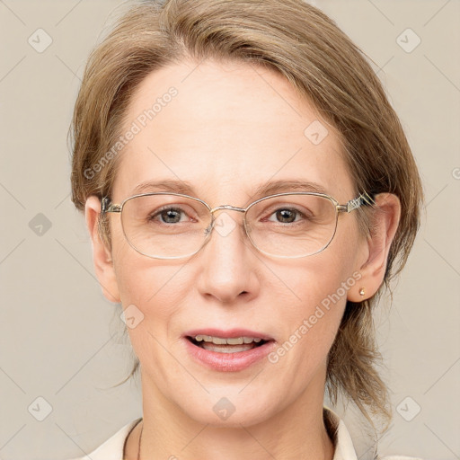 Joyful white adult female with medium  brown hair and blue eyes