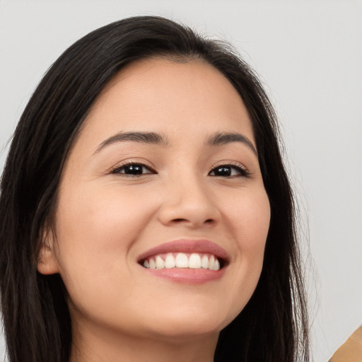 Joyful white young-adult female with long  brown hair and brown eyes