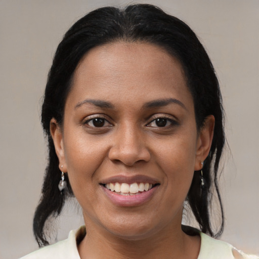 Joyful black young-adult female with medium  brown hair and brown eyes
