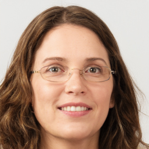 Joyful white young-adult female with long  brown hair and green eyes