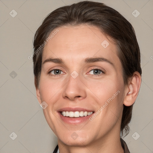 Joyful white young-adult female with medium  brown hair and grey eyes