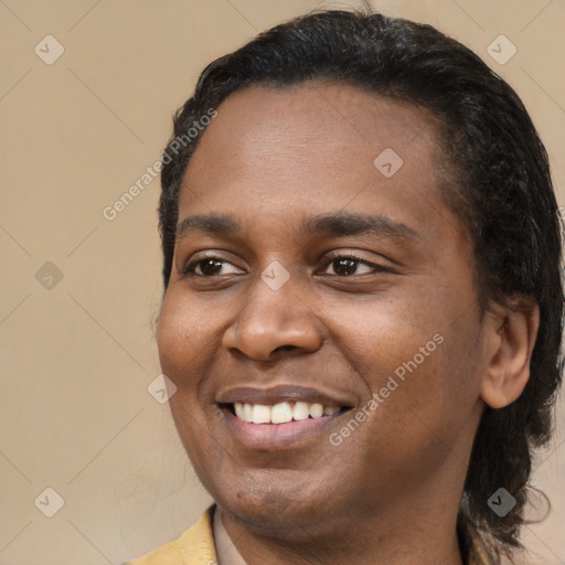 Joyful black young-adult male with short  black hair and brown eyes