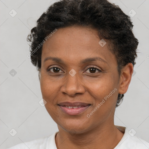 Joyful black adult female with short  brown hair and brown eyes