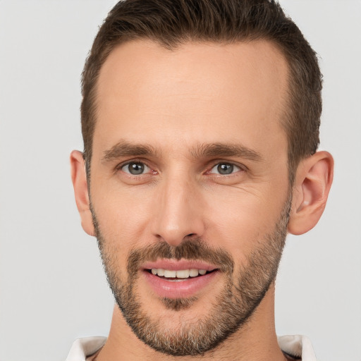 Joyful white young-adult male with short  brown hair and brown eyes