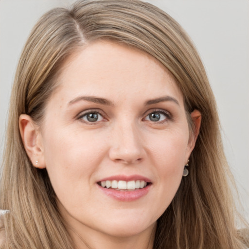 Joyful white young-adult female with long  brown hair and grey eyes