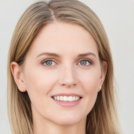 Joyful white young-adult female with long  brown hair and blue eyes