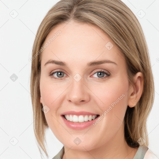 Joyful white young-adult female with medium  brown hair and green eyes