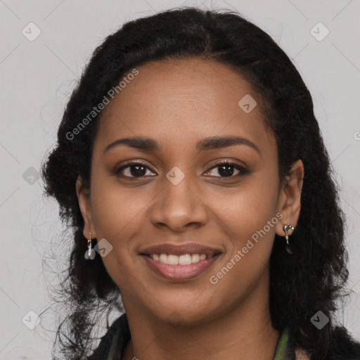 Joyful black young-adult female with long  black hair and brown eyes