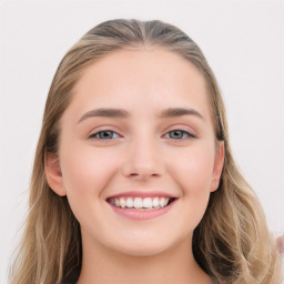 Joyful white young-adult female with long  brown hair and blue eyes