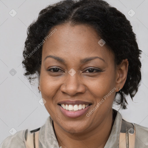 Joyful black adult female with short  brown hair and brown eyes