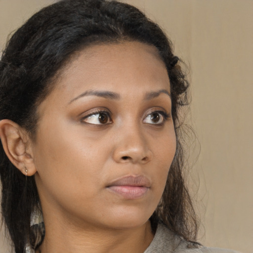 Neutral black young-adult female with medium  brown hair and brown eyes
