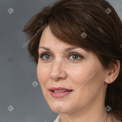 Joyful white adult female with medium  brown hair and brown eyes