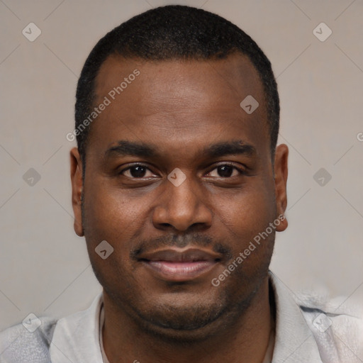 Joyful black young-adult male with short  brown hair and brown eyes