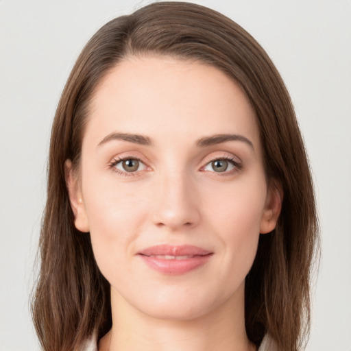 Joyful white young-adult female with long  brown hair and green eyes